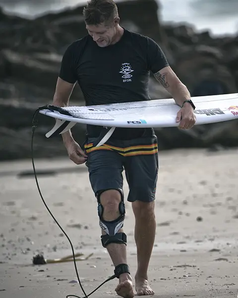 Mick Fanning wearing a K8 Knee Brace while surfing.